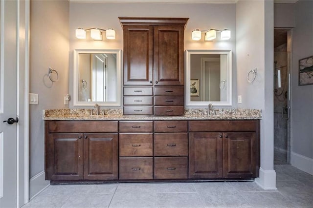 bathroom with vanity, a shower, and tile patterned floors