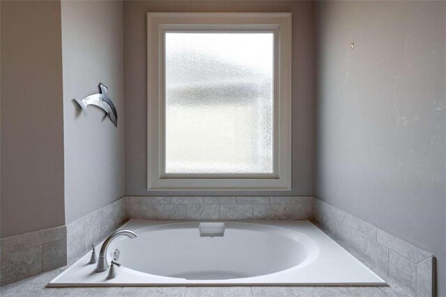 bathroom featuring a relaxing tiled tub