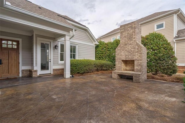 view of patio featuring an outdoor brick fireplace