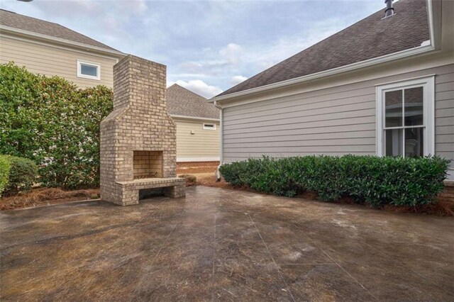 view of patio featuring a brick fireplace