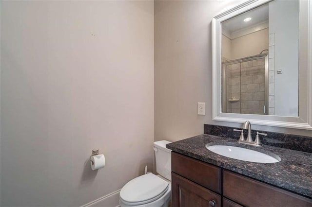 bathroom featuring vanity, toilet, and an enclosed shower