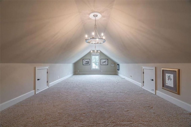 bonus room with lofted ceiling, a chandelier, and carpet floors