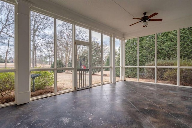 unfurnished sunroom featuring ceiling fan