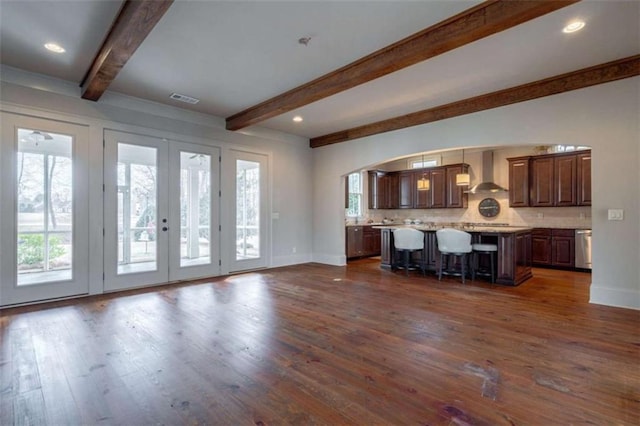 unfurnished living room with dark wood-type flooring and a wealth of natural light