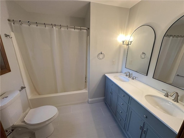 full bathroom with double vanity, shower / tub combo, toilet, and a sink