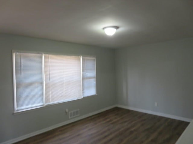 spare room featuring dark hardwood / wood-style flooring