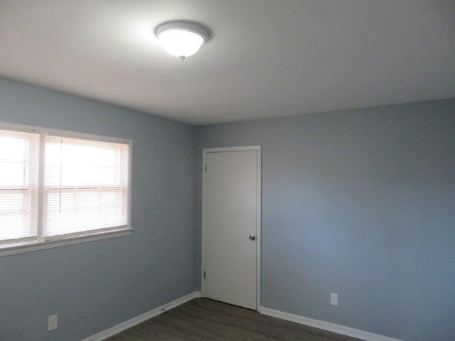 spare room featuring dark hardwood / wood-style flooring