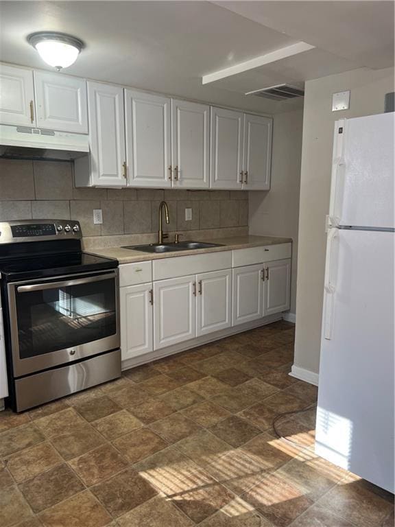 kitchen with white cabinetry, sink, white refrigerator, backsplash, and electric stove