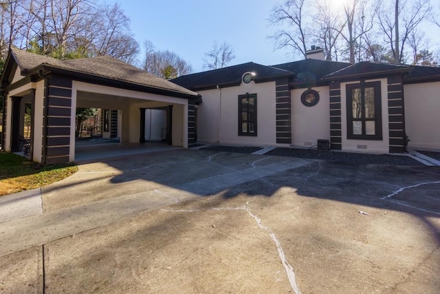 ranch-style house featuring a carport