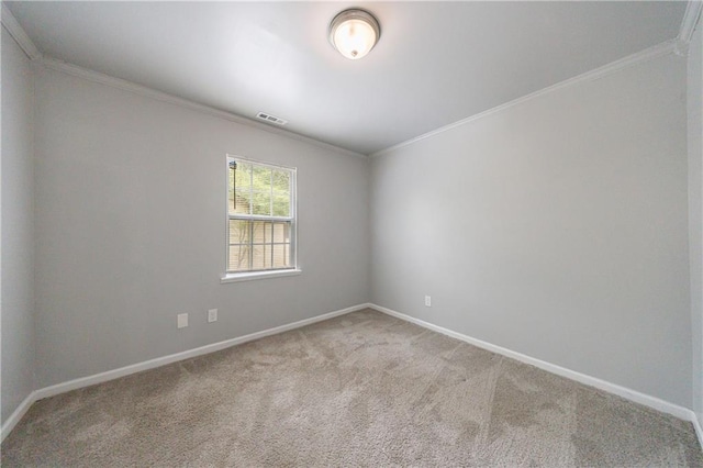 carpeted empty room featuring baseboards, visible vents, and crown molding