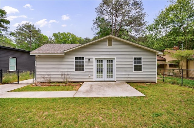 back of property with fence, a patio, a lawn, and french doors