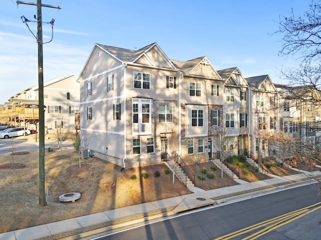 townhome / multi-family property featuring central AC