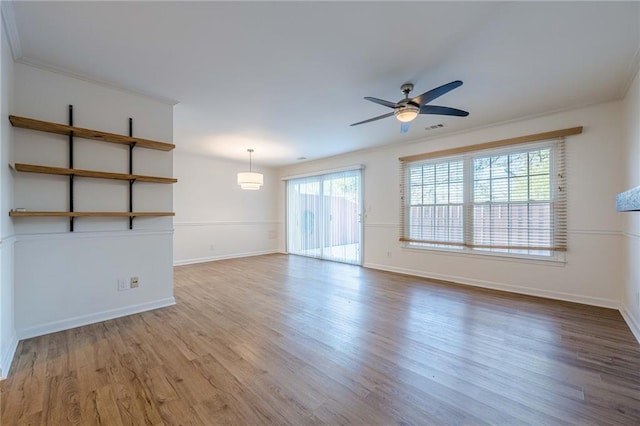 empty room with hardwood / wood-style floors and ceiling fan