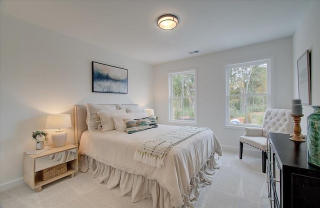 bedroom featuring light colored carpet