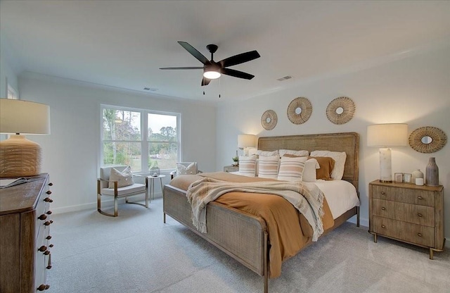 bedroom with ceiling fan and light carpet