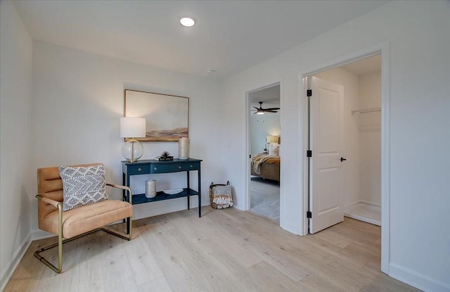 sitting room featuring light hardwood / wood-style flooring and ceiling fan