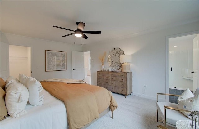 bedroom with ceiling fan, light colored carpet, a spacious closet, and a closet