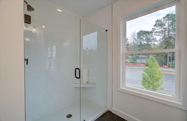 bathroom with tile patterned flooring and a shower with shower door