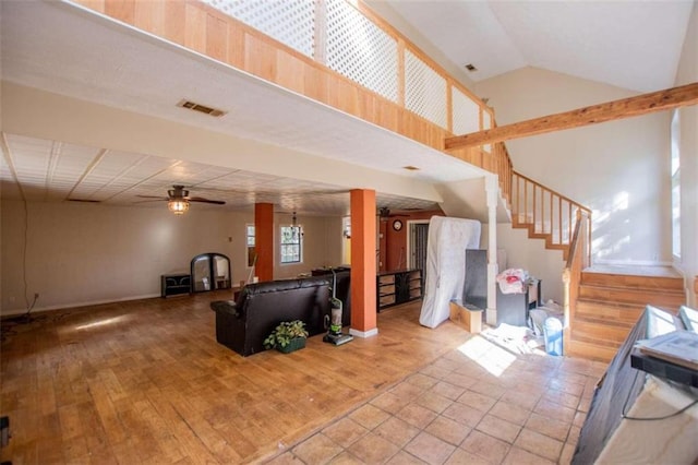 living room featuring high vaulted ceiling, light hardwood / wood-style floors, and ceiling fan