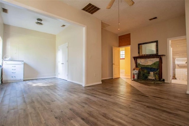 unfurnished living room featuring wood-type flooring and ceiling fan