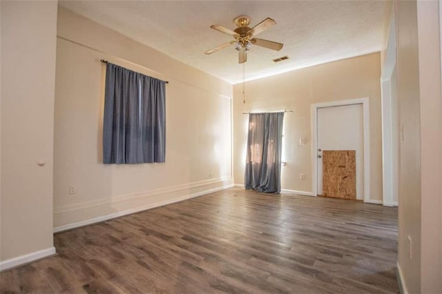 empty room with dark hardwood / wood-style floors and ceiling fan