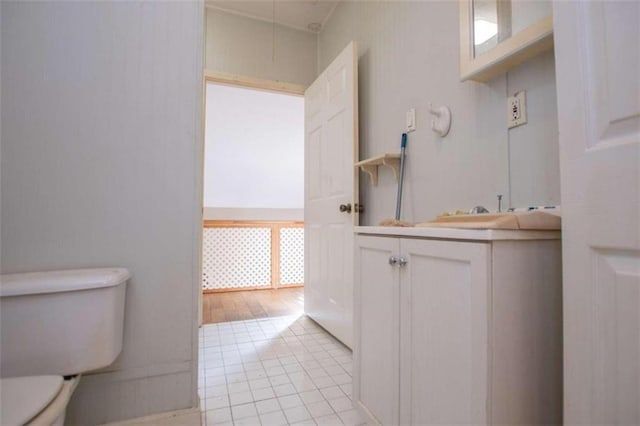 bathroom featuring vanity, tile patterned floors, and toilet