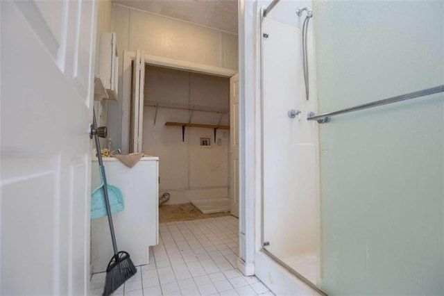 bathroom featuring washer / dryer, tile patterned floors, and walk in shower