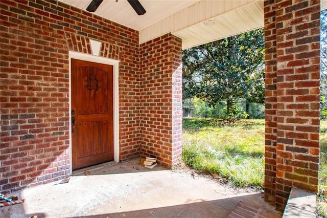 view of exterior entry with ceiling fan