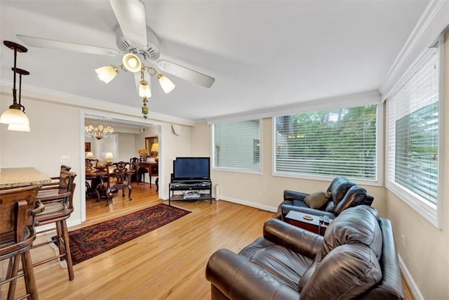 30 Chaumont Sq NW, Atlanta, GA 30327 - living area with wood finished floors, healthy amount of natural light, crown molding, ceiling fan, and a chandelier