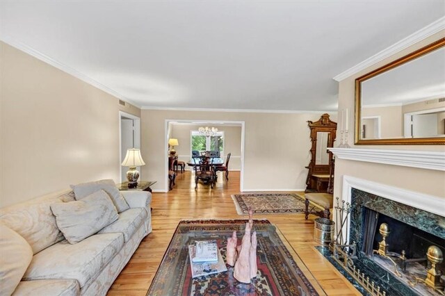 30 Chaumont Sq NW, Atlanta, GA 30327 - living room with a chandelier, wood finished floors, a fireplace, and crown molding