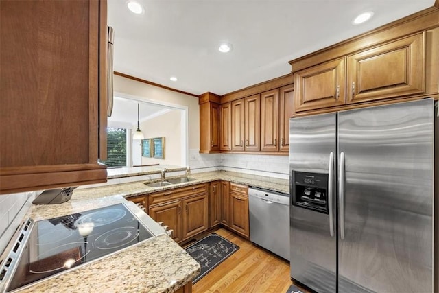 30 Chaumont Sq NW, Atlanta, GA 30327 - kitchen featuring stainless steel appliances, crown molding, brown cabinets, decorative backsplash, and light wood-style floors