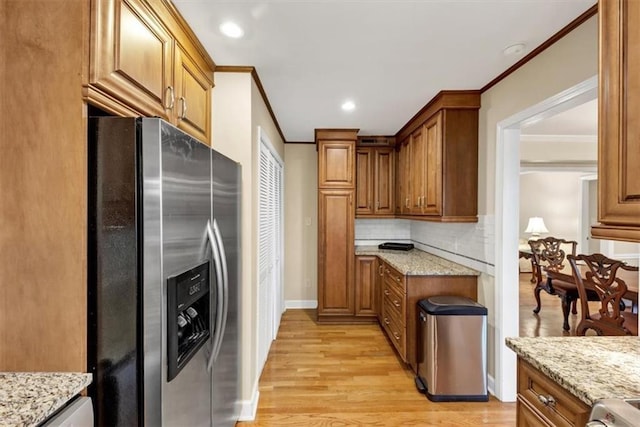 30 Chaumont Sq NW, Atlanta, GA 30327 - kitchen with stainless steel refrigerator with ice dispenser, crown molding, light wood-style floors, light stone counters, and backsplash