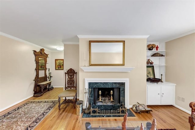 30 Chaumont Sq NW, Atlanta, GA 30327 - living area featuring wood finished floors, ornamental molding, and a fireplace with flush hearth