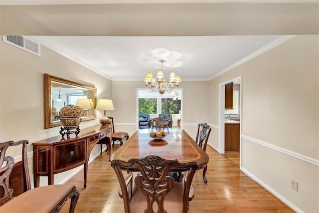 30 Chaumont Sq NW, Atlanta, GA 30327 - dining area featuring a chandelier, light wood finished floors, and crown molding