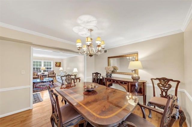 30 Chaumont Sq NW, Atlanta, GA 30327 - dining area with a chandelier, light wood-style floors, and ornamental molding