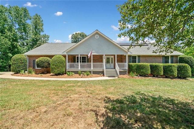 single story home featuring covered porch and a front lawn