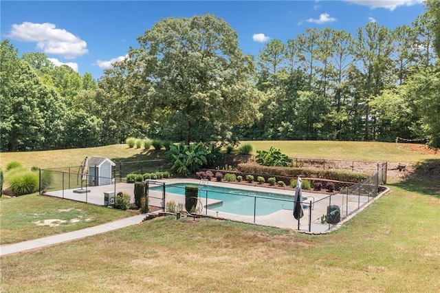 view of pool with a lawn, a storage unit, and a diving board