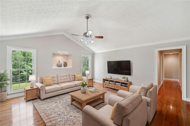 living room with lofted ceiling, ceiling fan, crown molding, and hardwood / wood-style floors