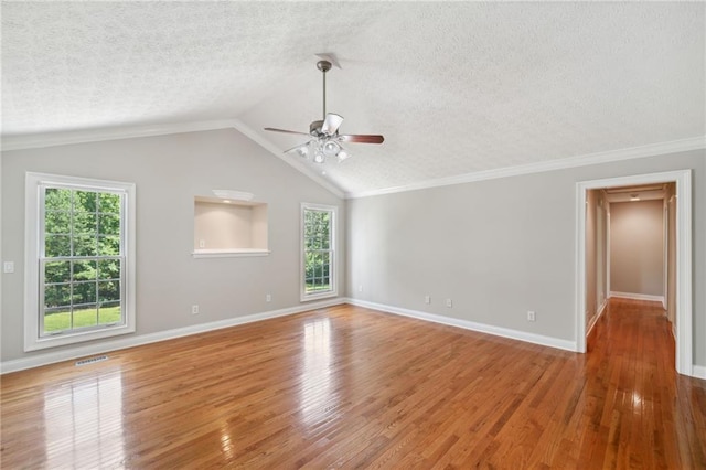 unfurnished room with hardwood / wood-style flooring, ceiling fan, a textured ceiling, and lofted ceiling