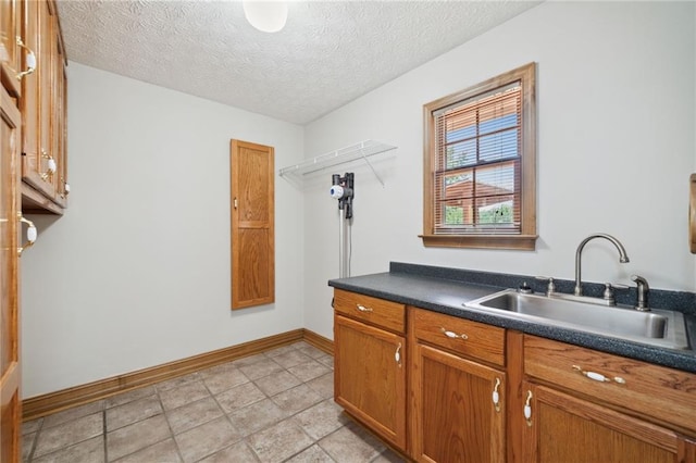 kitchen with sink and a textured ceiling