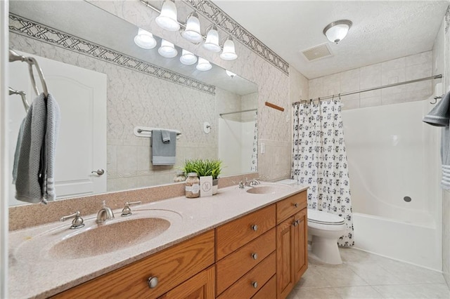 full bathroom with shower / bathtub combination with curtain, tile patterned flooring, toilet, tile walls, and vanity