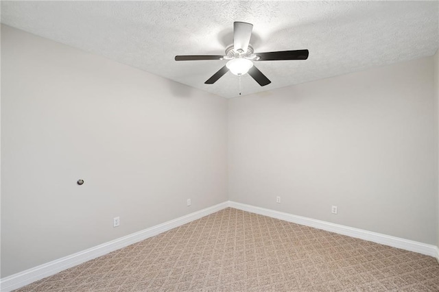 carpeted spare room with ceiling fan and a textured ceiling