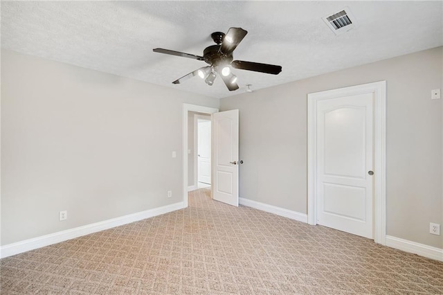 unfurnished bedroom featuring a textured ceiling, ceiling fan, and light colored carpet