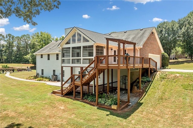 rear view of house featuring a yard, a deck, central AC, and a sunroom