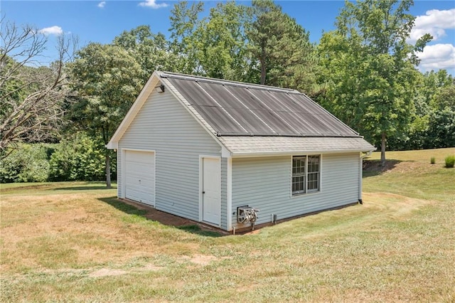 view of outdoor structure featuring a yard and a garage