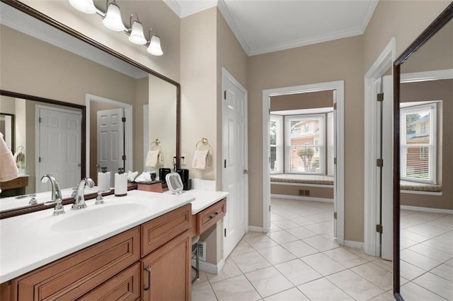 bathroom featuring ornamental molding, tile patterned flooring, vanity, and baseboards