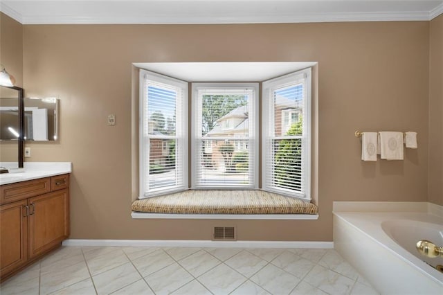 full bath with baseboards, vanity, a garden tub, and ornamental molding