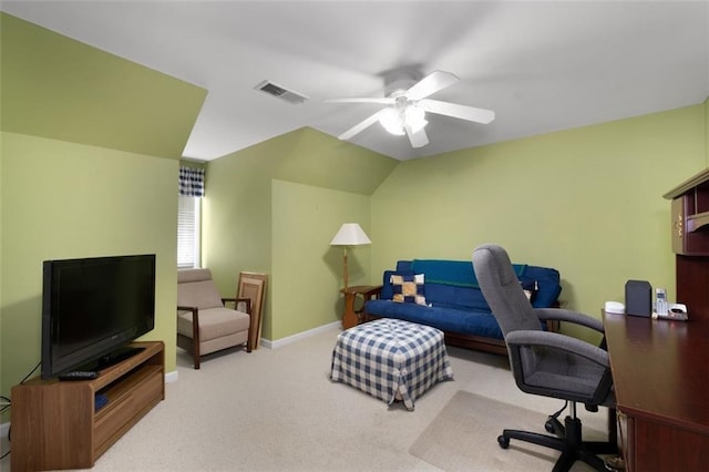 carpeted office space featuring a ceiling fan and baseboards