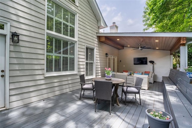 wooden deck with ceiling fan, an outdoor hangout area, and outdoor dining area
