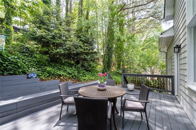 wooden terrace featuring outdoor dining area